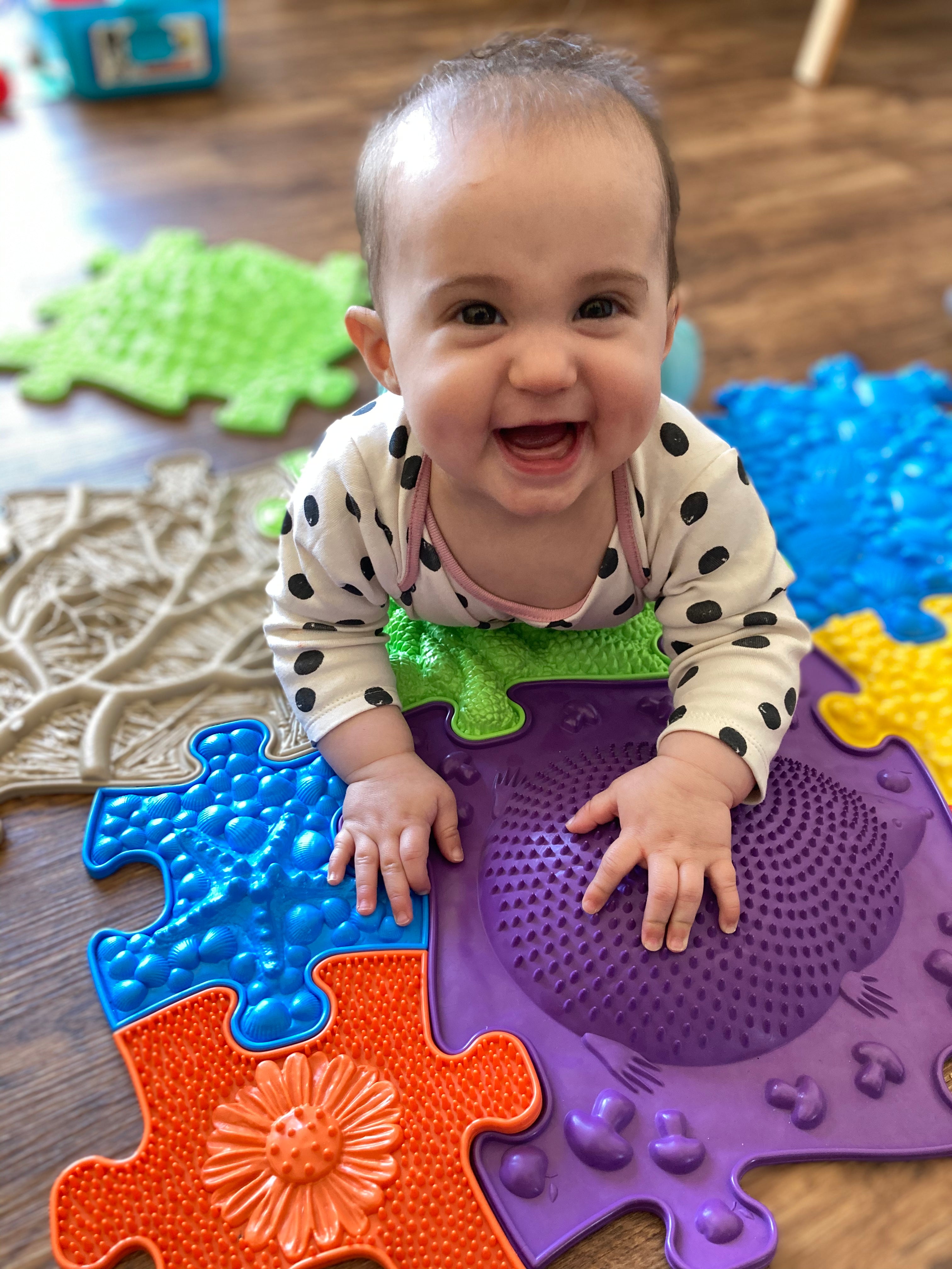 Tummy time on Happy Feet Play Mats - Sensory and tactile stimulation. Smiling baby is enjoying our Play Mats