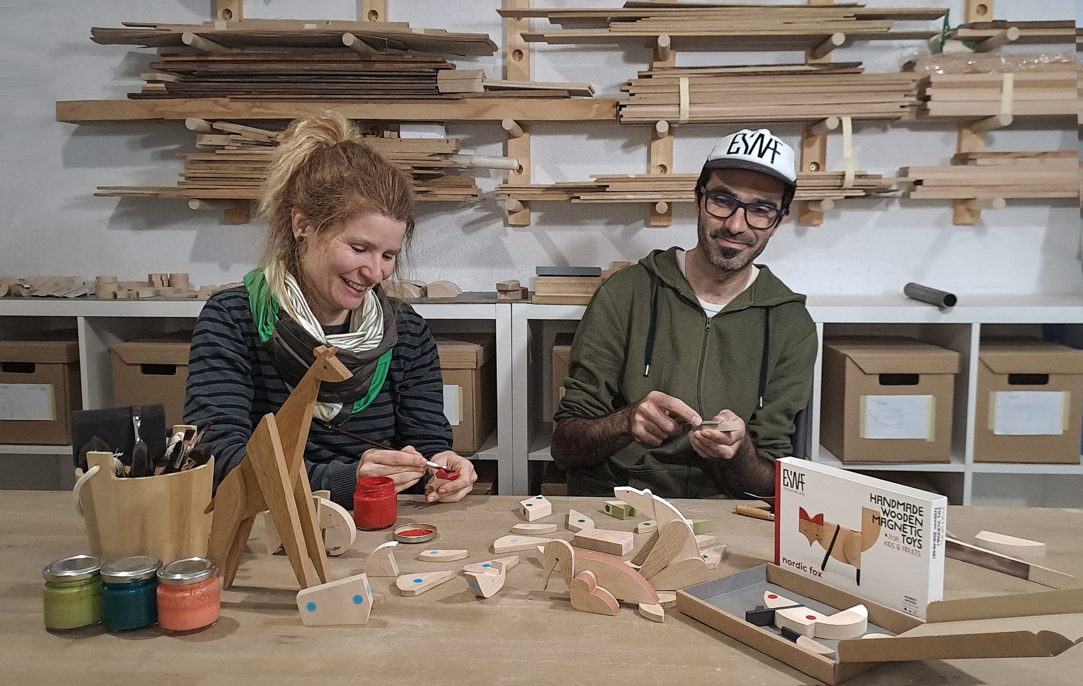 Esnaf workshop two people painting wooden toys